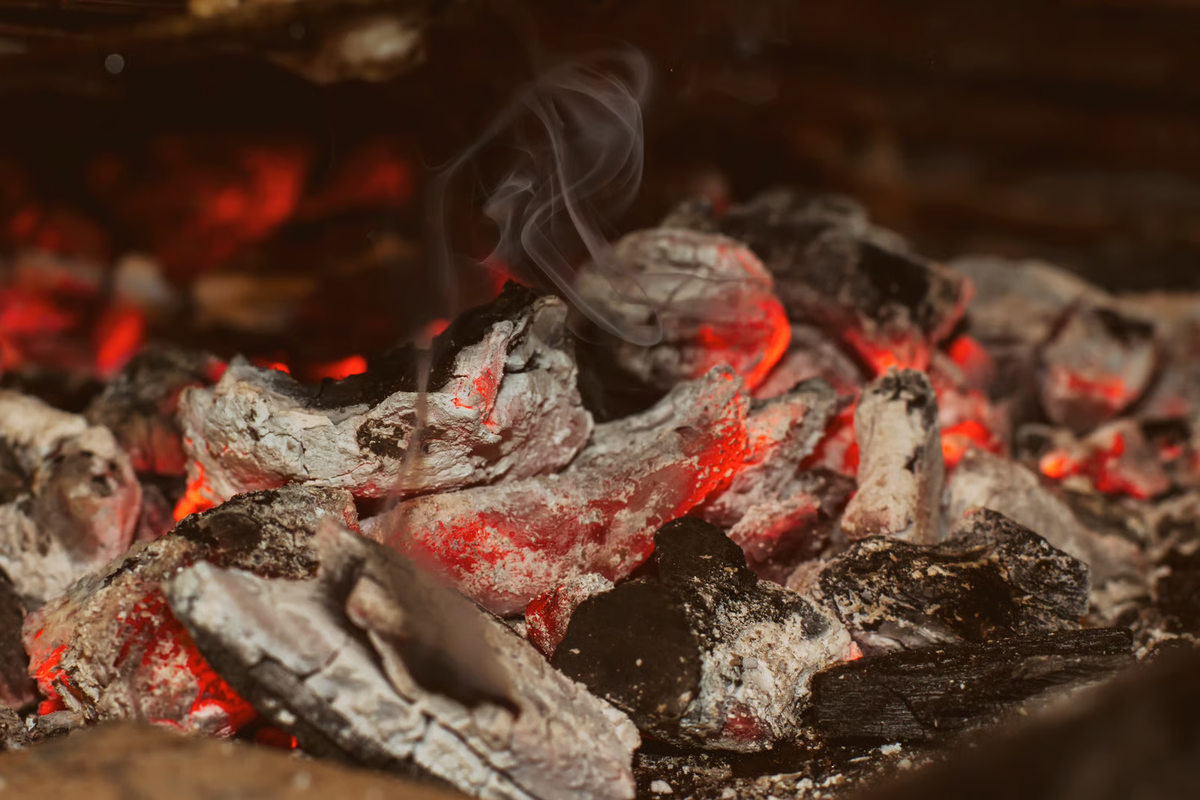Charcoal BBQ fire fading with grey ash and no glow, showing a fire that needs troubleshooting