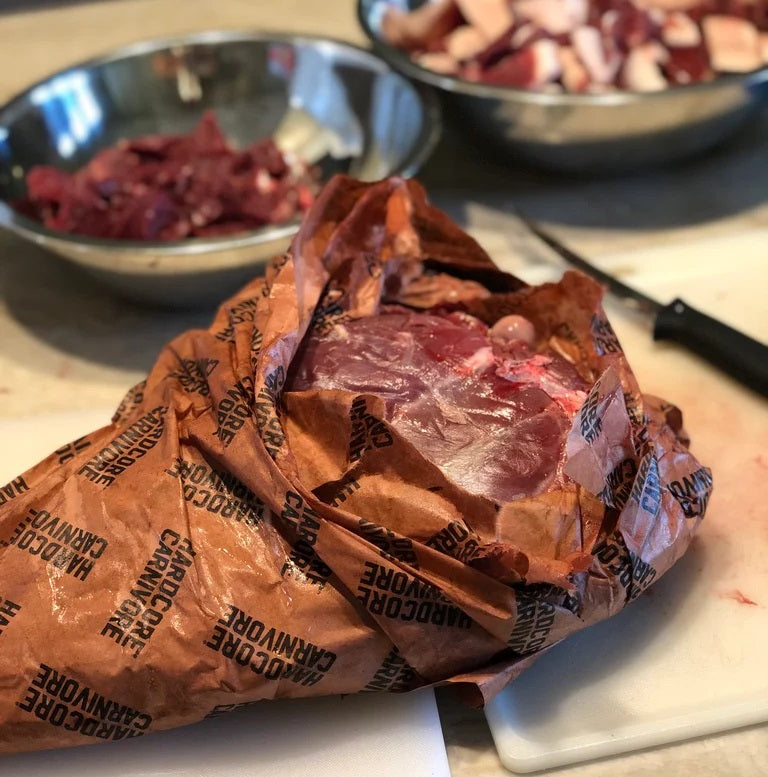 Smoked meat wrapped tightly in Hardcore Carnivore peach butcher paper