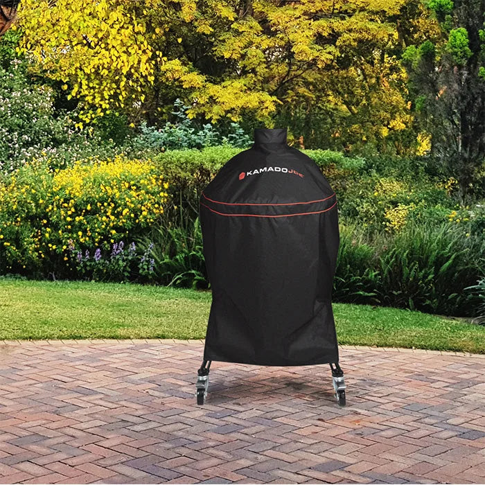 Kamado Joe Heavy-Duty Grill Cover in Big Joe size covering a grill and cart on a brick patio
