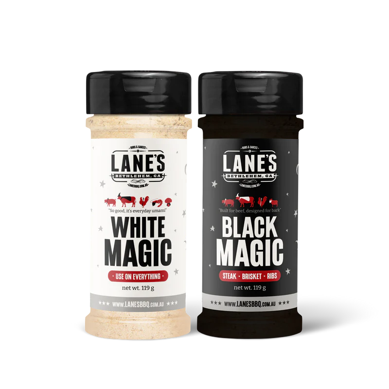Lane’s White Magic and Black Magic BBQ rub bottles on black background