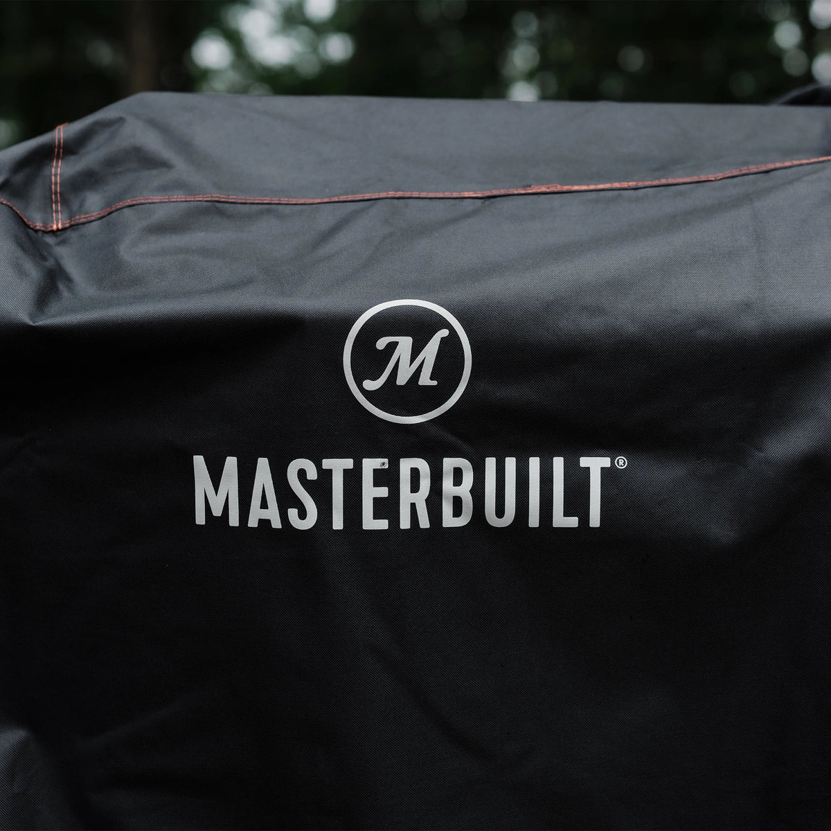 Close up of Masterbuilt logo and weather resistant material on BBQ cover