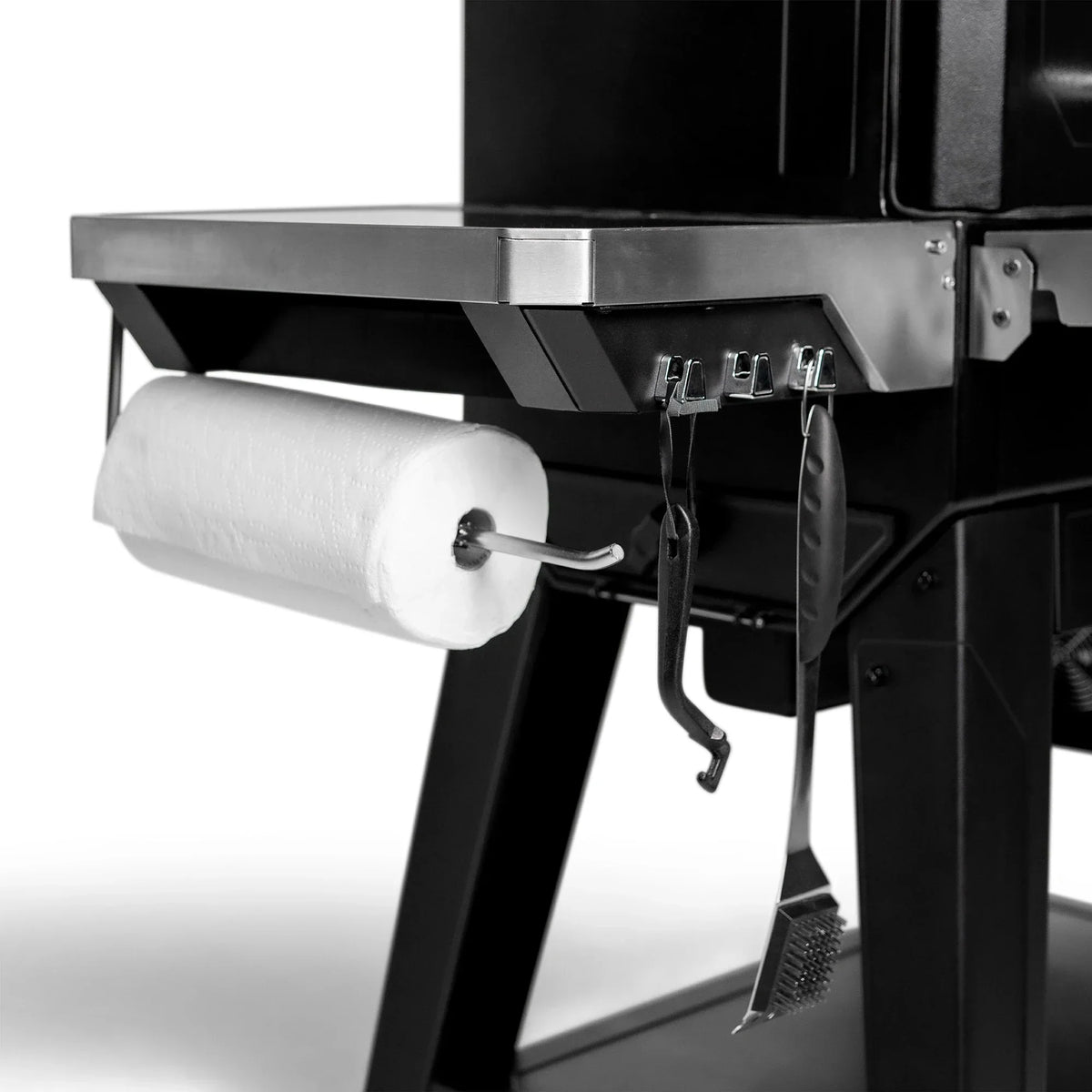 Masterbuilt Gravity Series XT Digital Charcoal BBQ featuring stainless steel side shelf with paper towel holder and integrated utensil hooks.