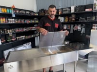 Elite stainless steel charcoal grill demonstration showing features, size and cooking setup