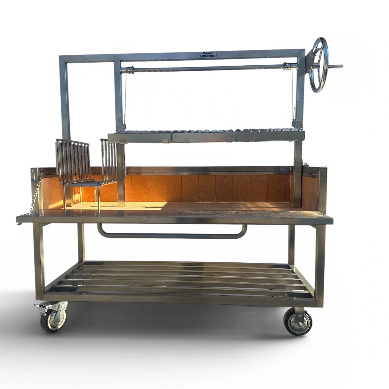 Sydney Barbecues Parrilla 1200 with front access panel removed, showing the removable brasero, 30 mm fire bricks and spacious firebox.