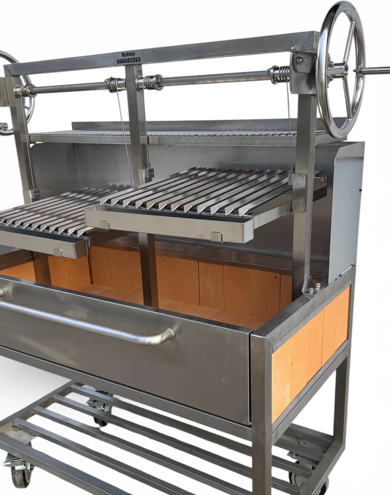 Close up of heavy duty 304 stainless steel Parrilla BBQ with dual adjustable V grates, fire bricks, and commercial charcoal cooking design.