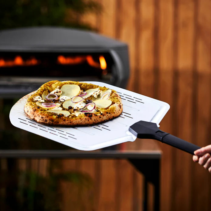 Witt Perforated Pizza Peel 14-inch removing pizza from oven