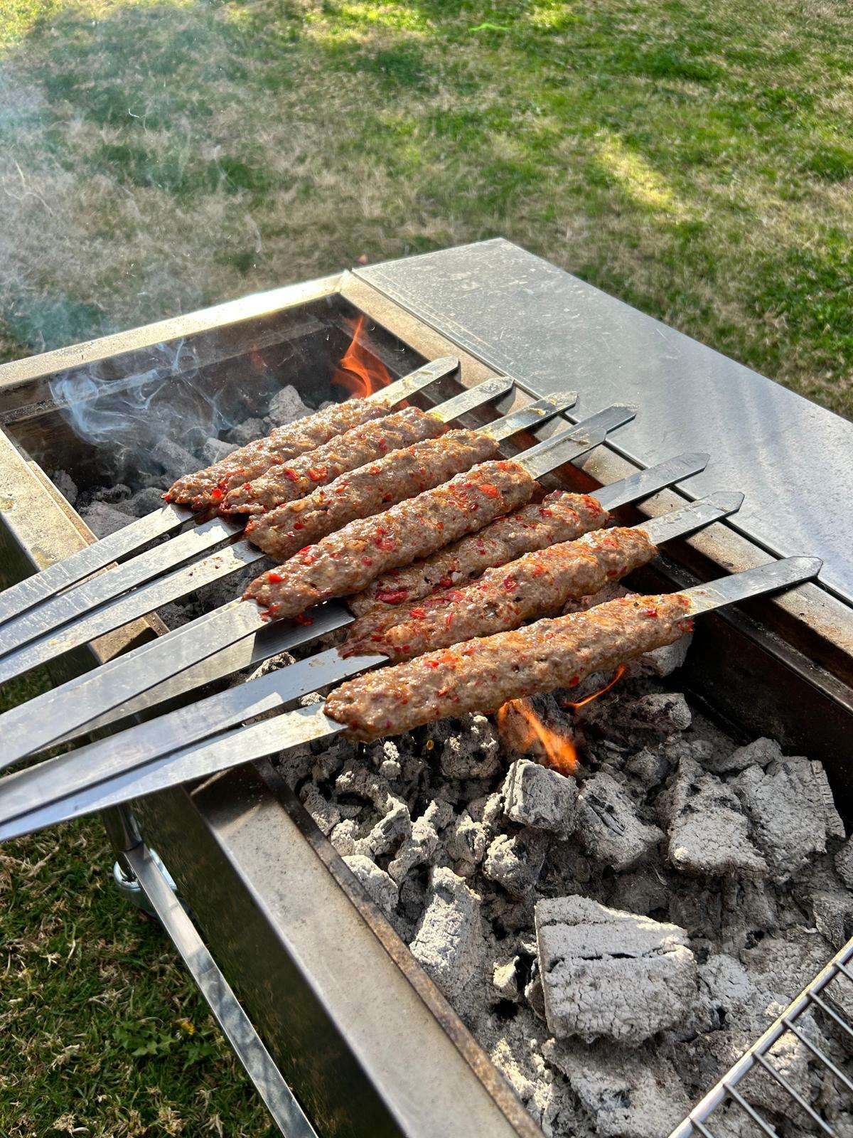 adana skewers on portable bbq side on