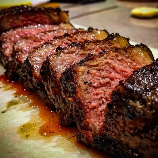 Juicy sliced beef tri-tip cooked using SuckleBusters SPG rub, showing crust and smoke ring