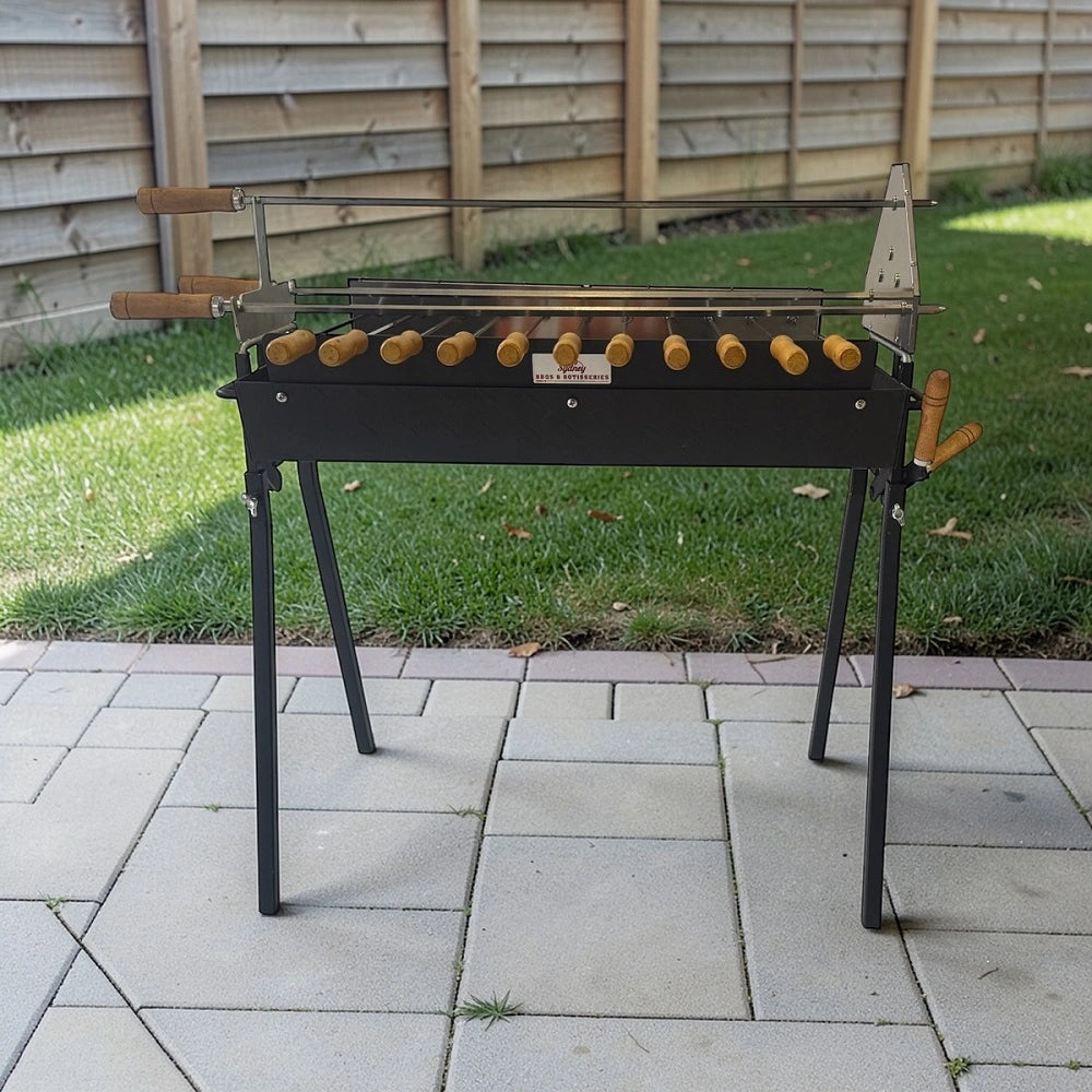 Cyprus spit charcoal BBQ in backyard on grass cooking skewers over charcoal