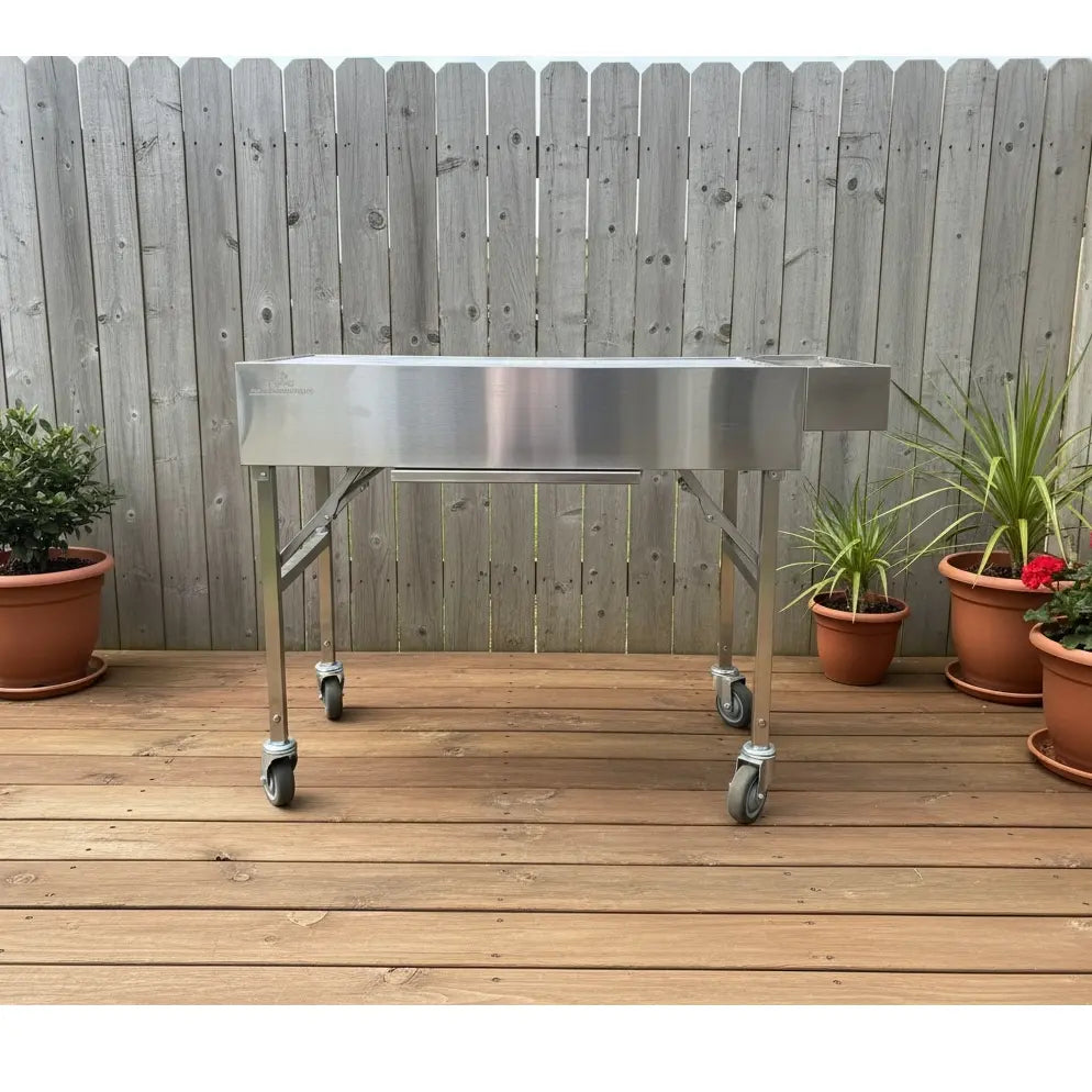 Family Portable BBQ set up on timber deck with potted plants in background