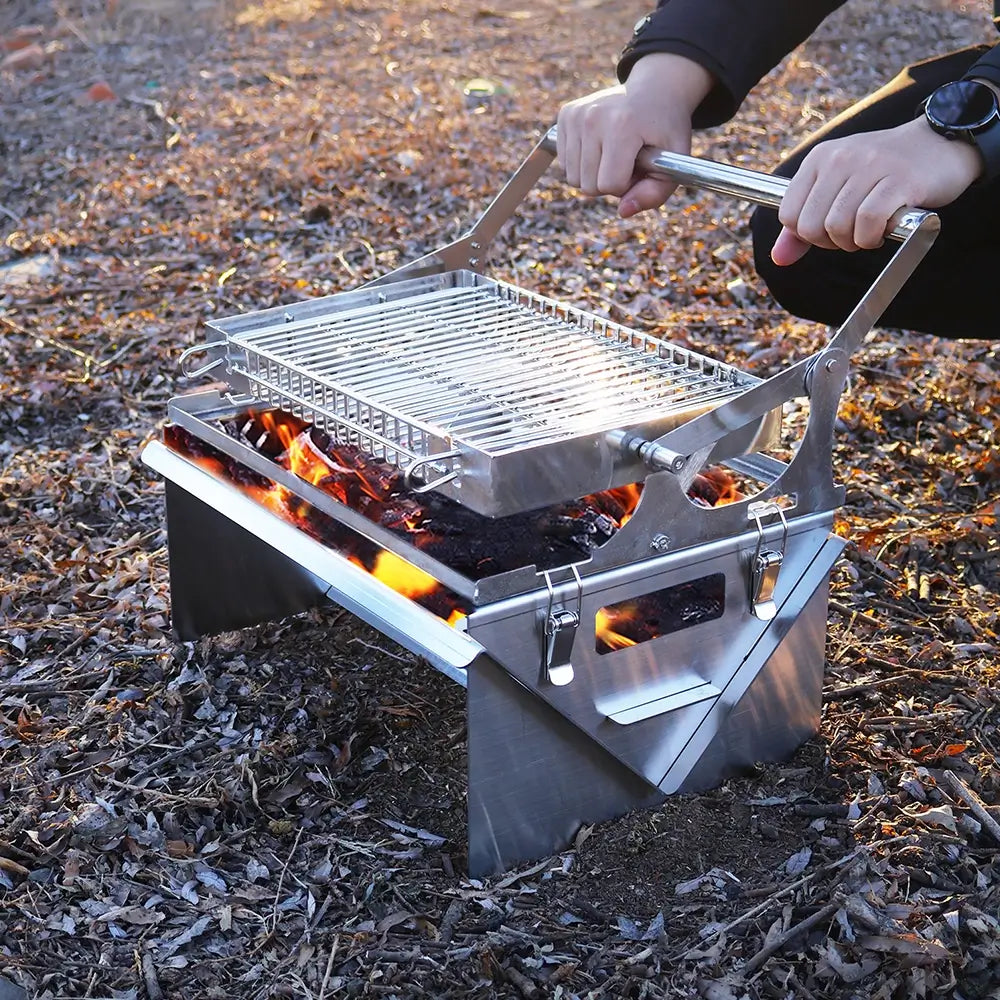 Compact Flip Grill being used outdoors with charcoal for camping BBQ