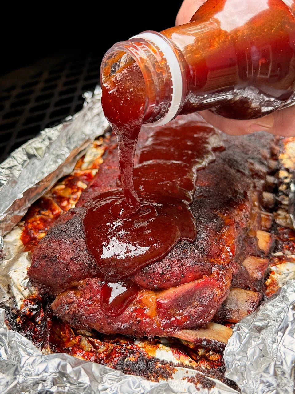 Hardcore Carnivore Saucesome BBQ sauce glazed over smoked BBQ meat