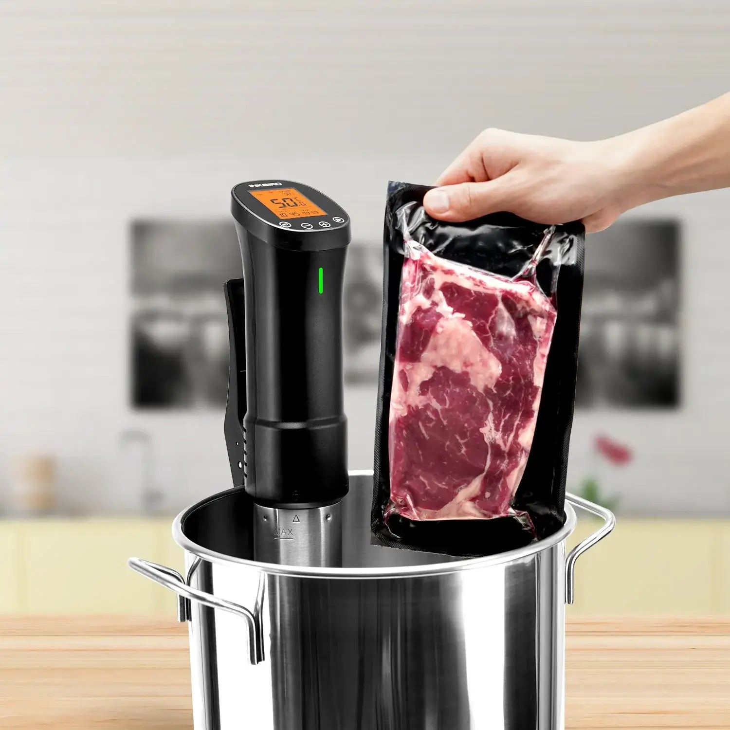 Sous vide beef sealed in bag with Inkbird WiFi cooker in pot