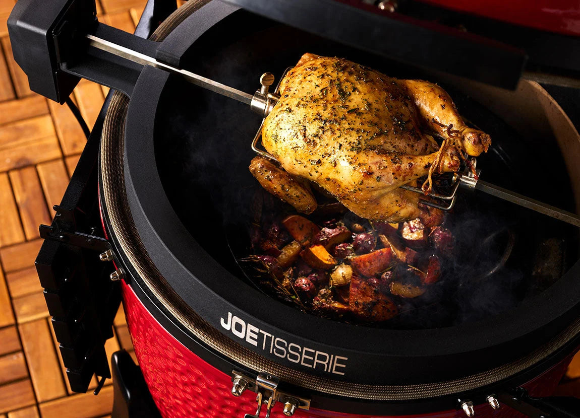 Whole chicken turning on the JoeTisserie spit in a Kamado Joe