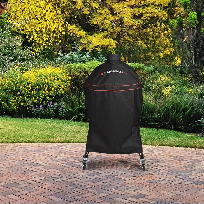 Kamado Joe grill cover protecting a kamado on a backyard patio