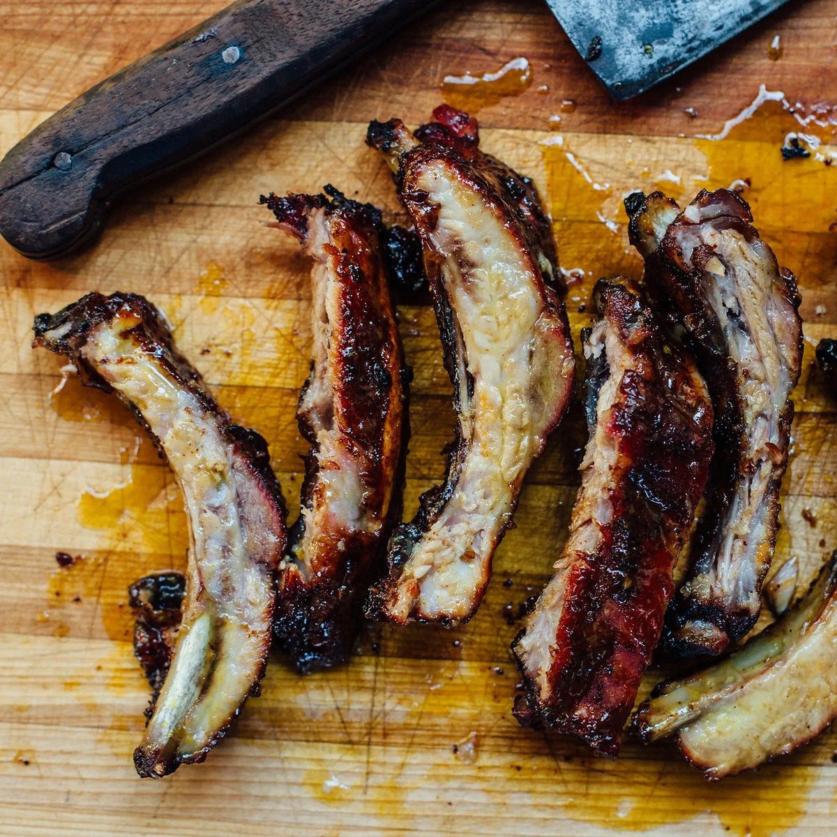 Cooked ribs removed from the Kamado Joe stainless steel rib rack