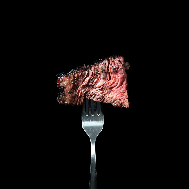Sliced steak cooked with Lane’s Black Magic BBQ rub showing dark crust and juicy centre