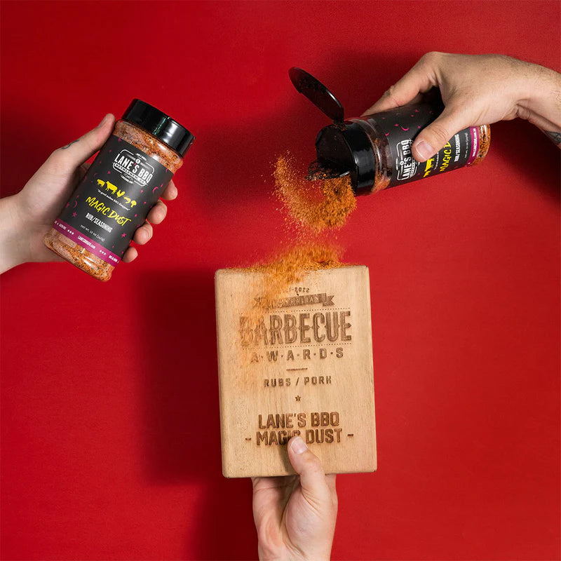 Lane’s Magic Dust BBQ rub being poured onto an award made from wood
