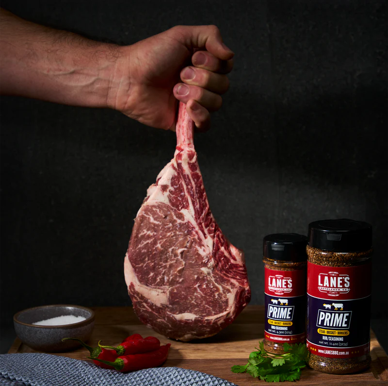 Tomahawk steak seasoned with Lane’s Prime Rub showing bold crust and beef seasoning setup