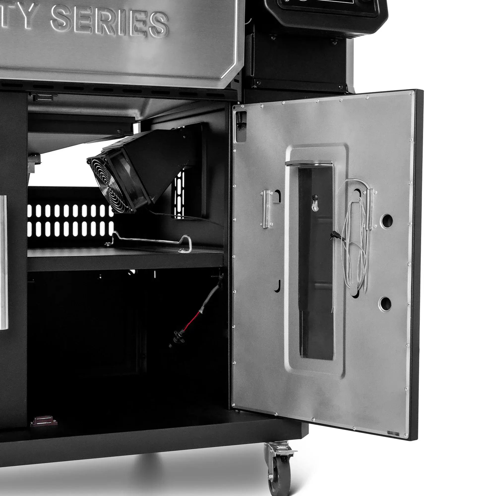 Cabinet with open door and charcoal management fan on the Gravity Series 1150