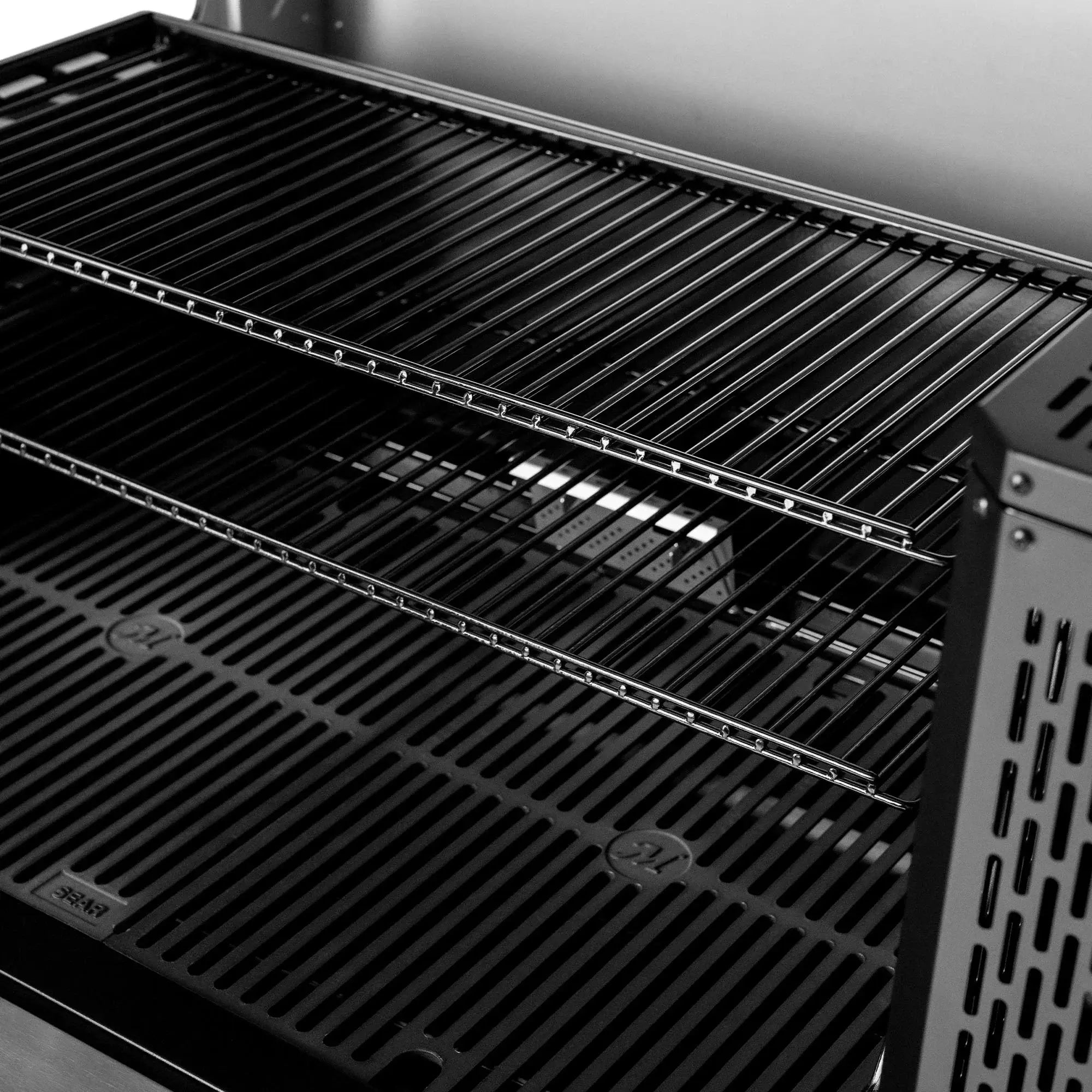 Close up of reversible cast iron Smoke and Sear cooking grates on the Gravity Series 1150
