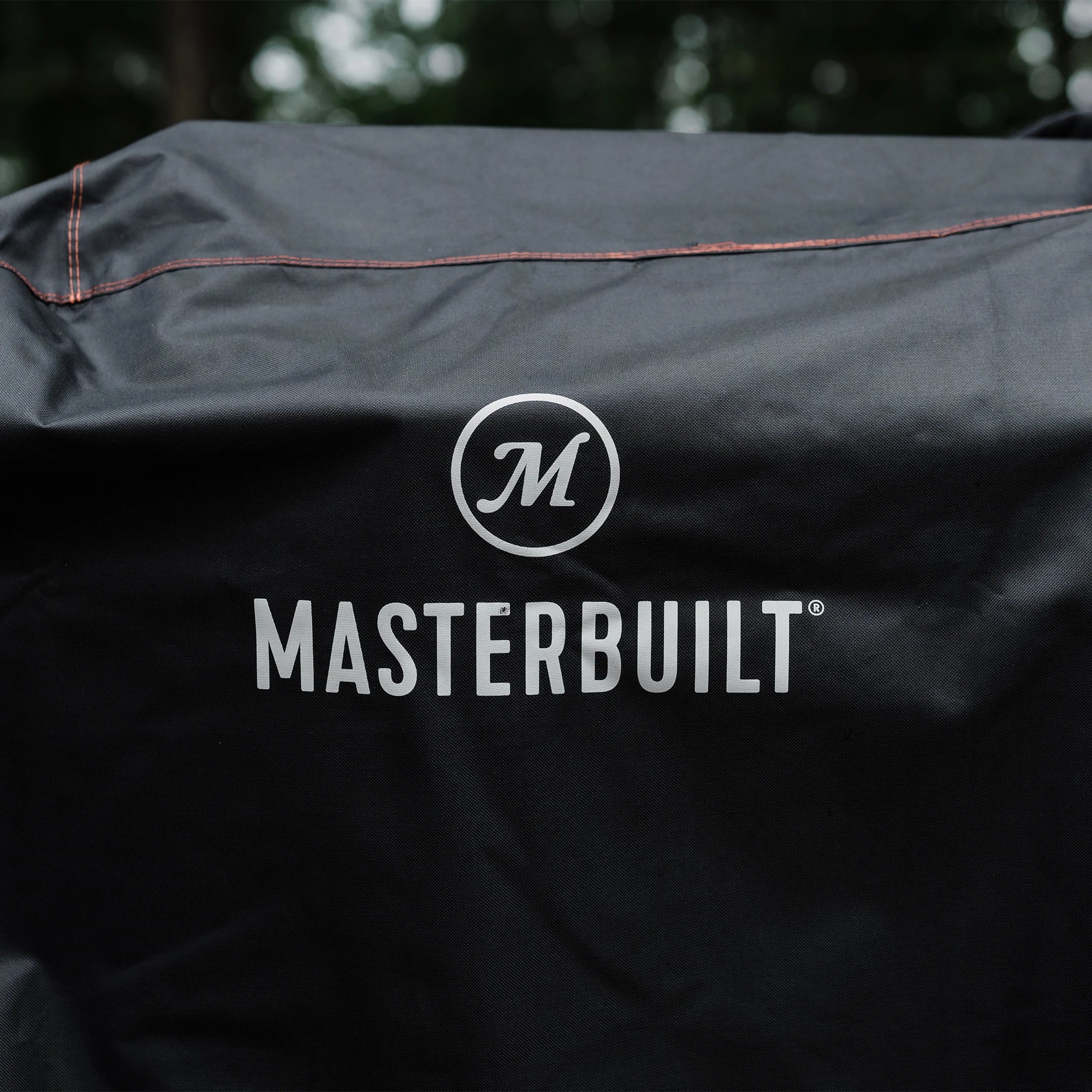 Close up of Masterbuilt logo and weather resistant material on BBQ cover