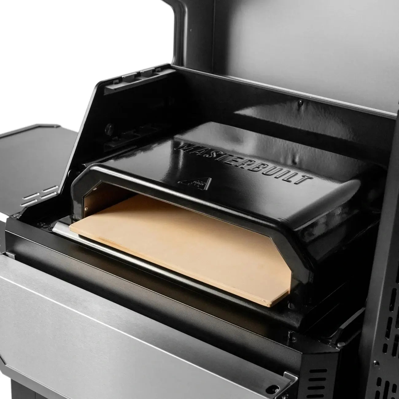 Masterbuilt pizza oven attachment installed inside a Gravity Series charcoal BBQ
