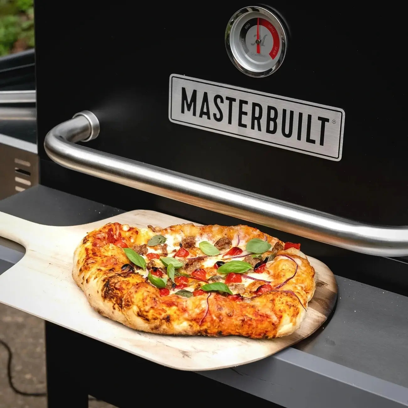 Finished homemade pizza cooked on the Masterbuilt pizza oven attachment