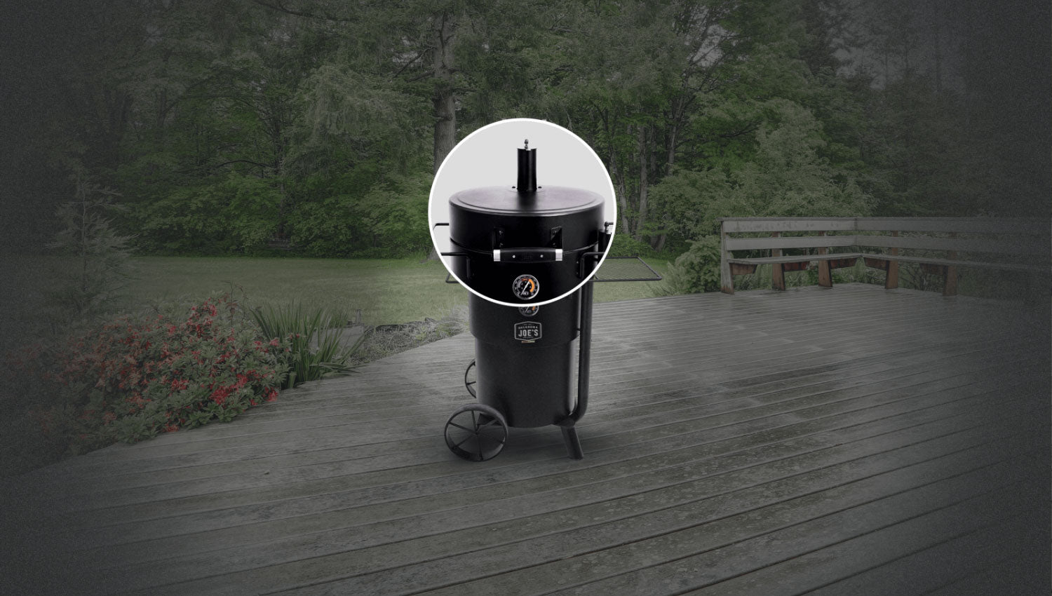 Oklahoma Joe’s Bronco Drum Smoker placed in outdoor garden setting