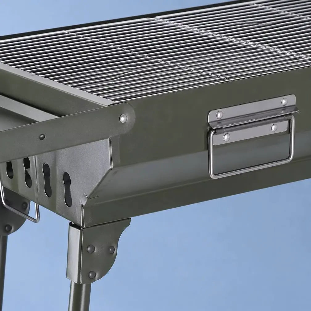 Close up of portable charcoal BBQ metal body cooking grate and folding carry handle