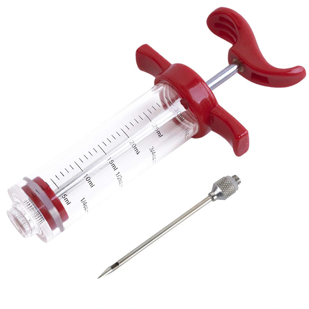 Disassembled meat injector showing stainless steel needle, plunger and clear barrel components