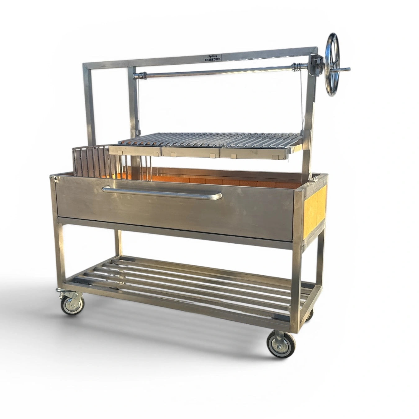 Sydney Barbecues Parrilla 1200 with adjustable cooking grill raised using the traditional Argentine wheel mechanism.