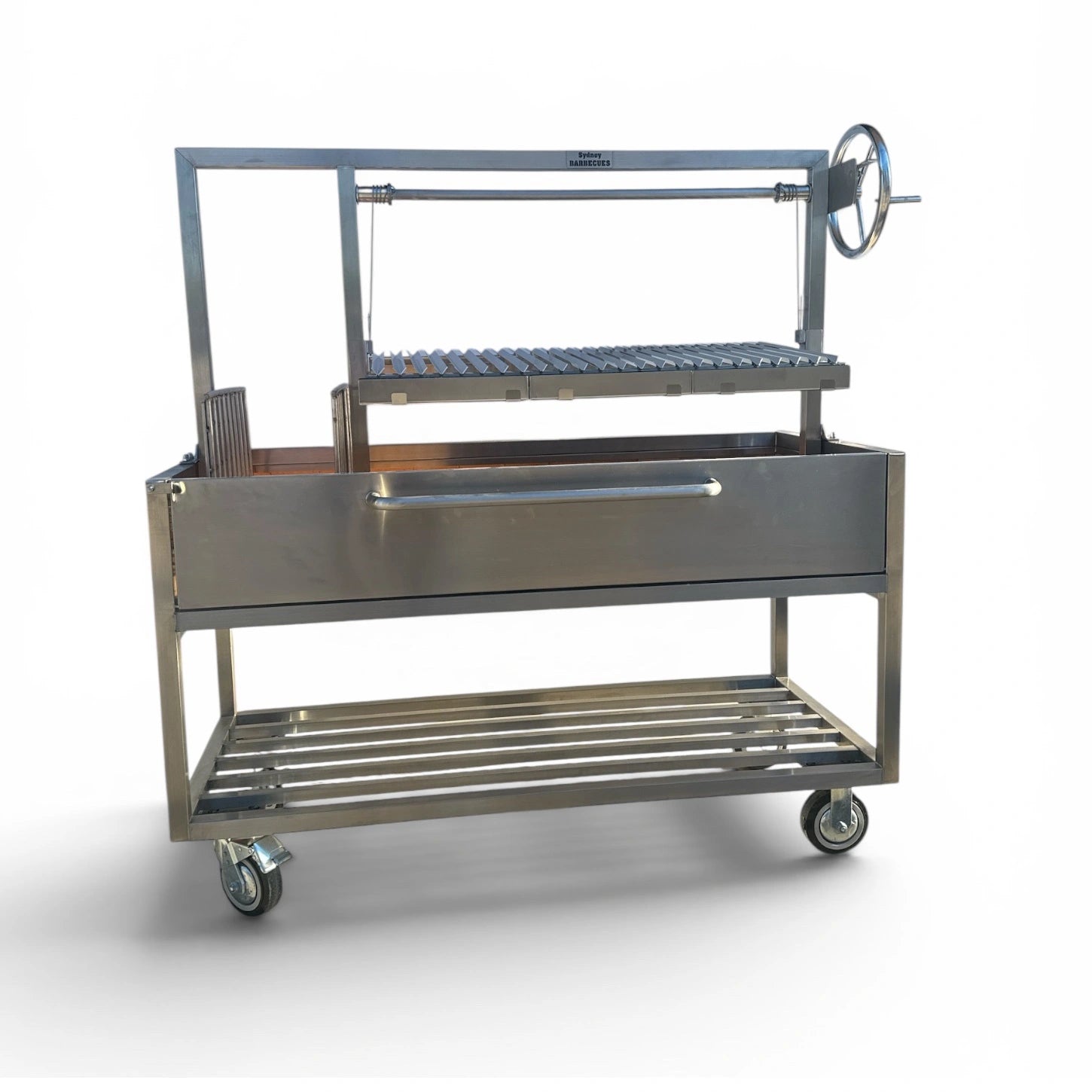 Side view of the Sydney Barbecues Parrilla 1200 showing the commercial grade stainless steel frame and adjustable cooking grill.