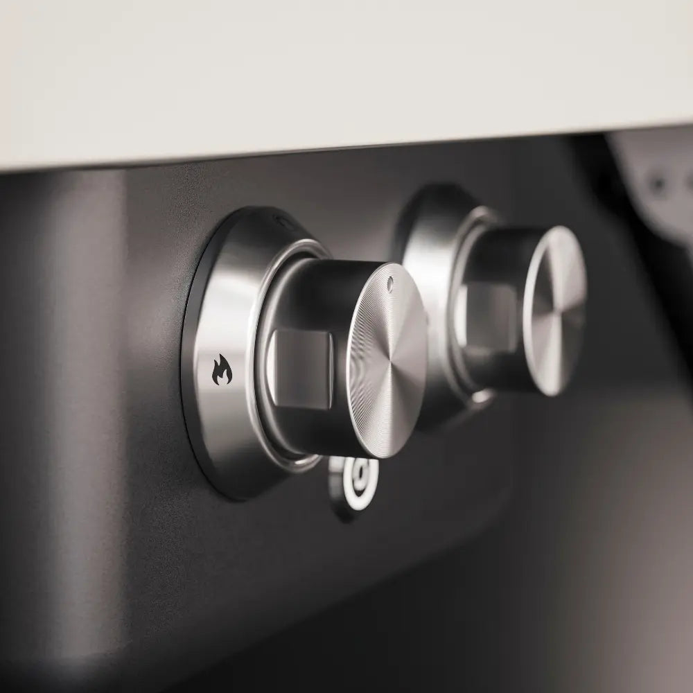 Close-up of dual burner control knobs on the WITT Etna Rotante gas pizza oven