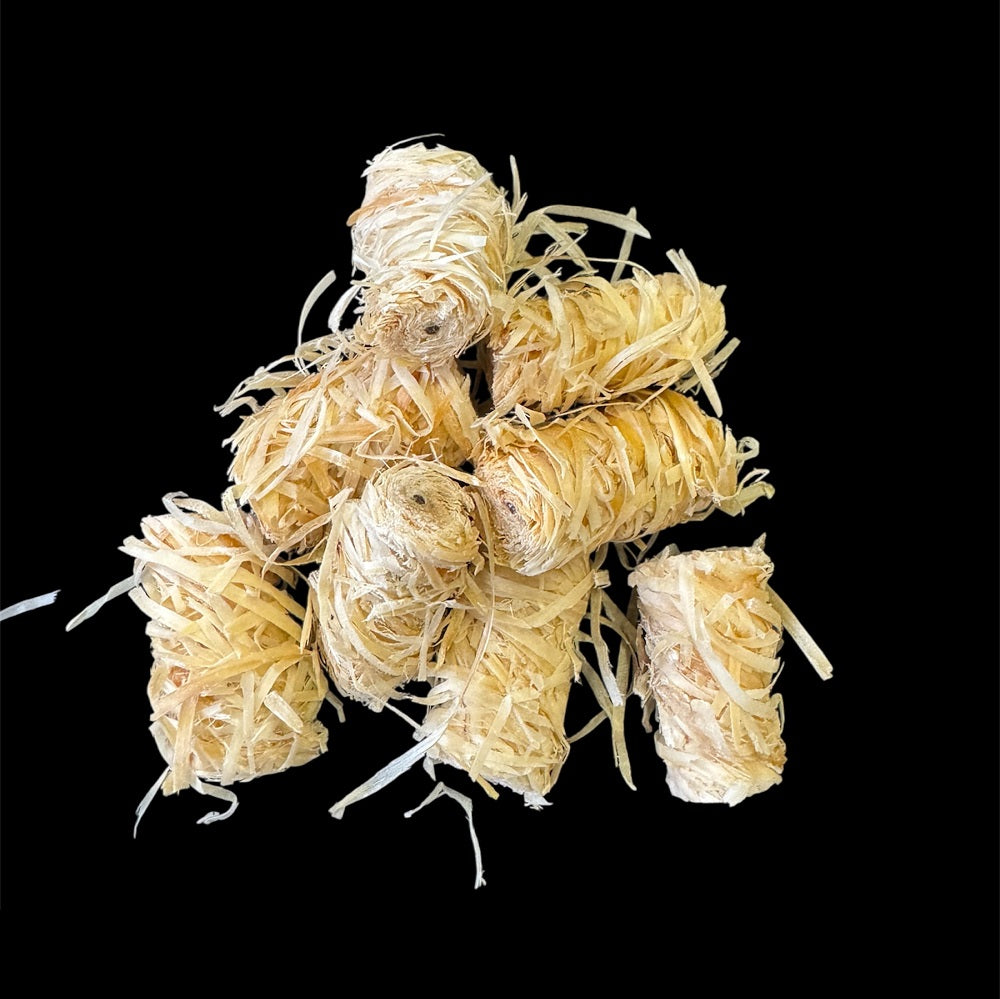 Pile of natural wood wool firelighters made from wax and wood fibres – chemical-free and odourless

