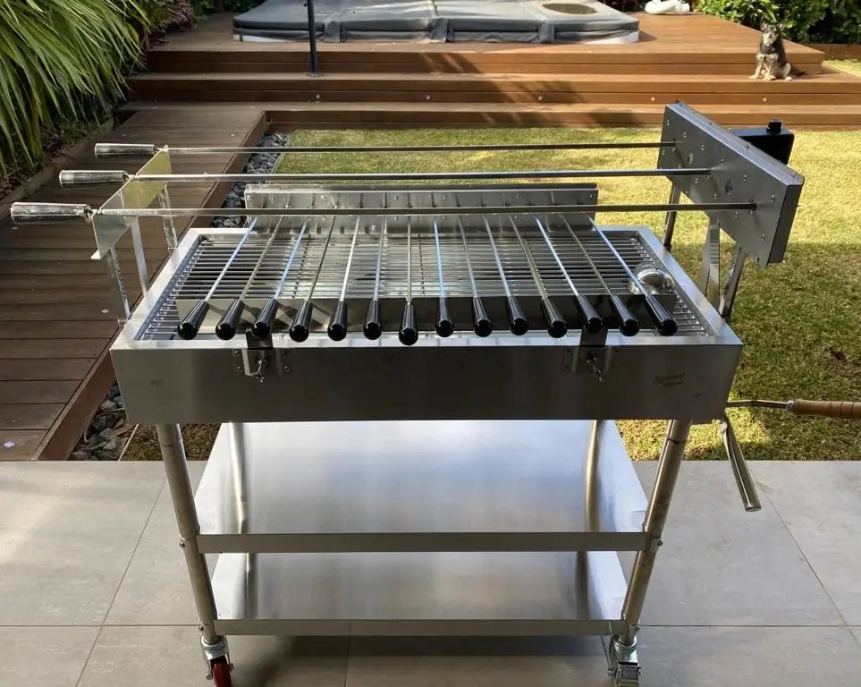 Stainless steel XL rotisserie grill with full skewer set in backyard